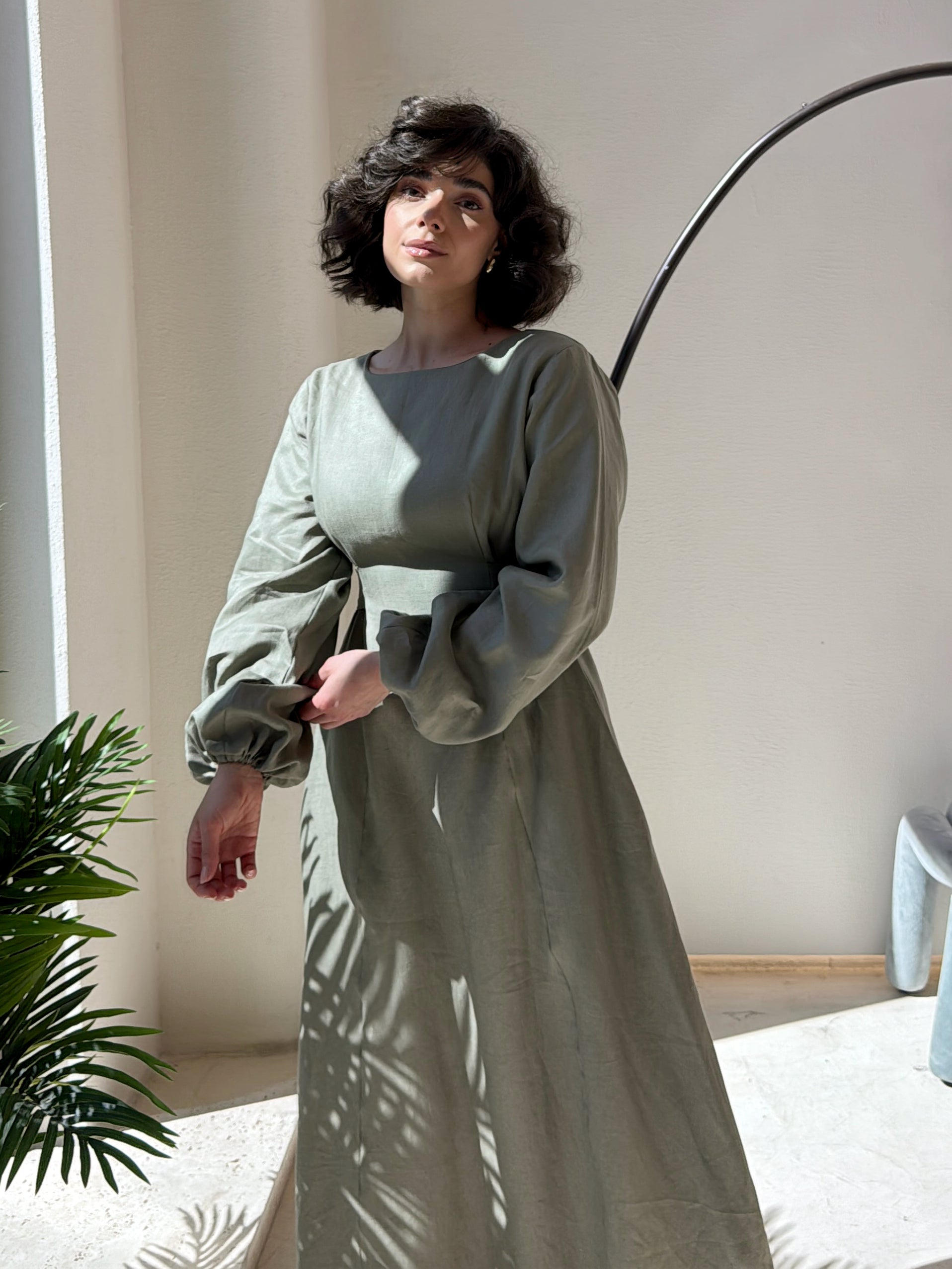 Modest long, light-colored dress with belt